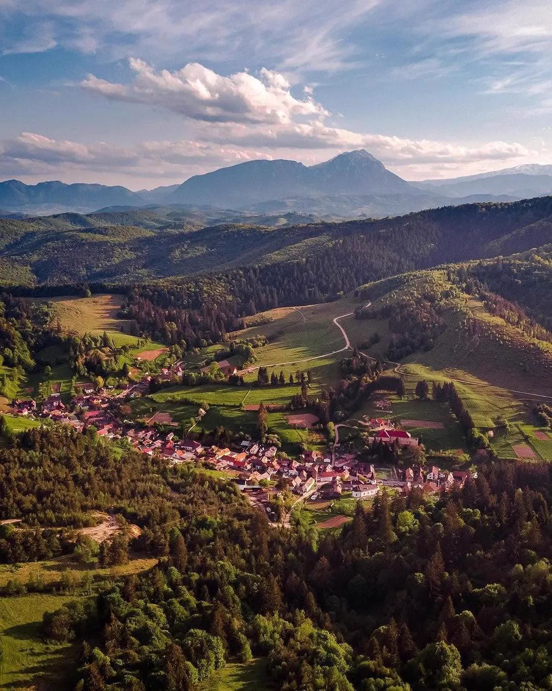 Aerial view over Holbav village with the Bucegi Mountains
